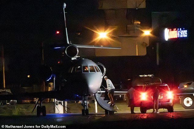 Travis Kelce has been spotted leaving Taylor Swift's ritzy Rhode Island mansion via private plane in a midnight getaway during a party to mark Blake Lively's 37th birthday. (Pictured: Kelce boarding the private plane in the early hours of Monday morning)