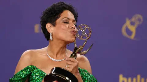 Reuters Liza Colon-Zayas kissing her Emmy Award