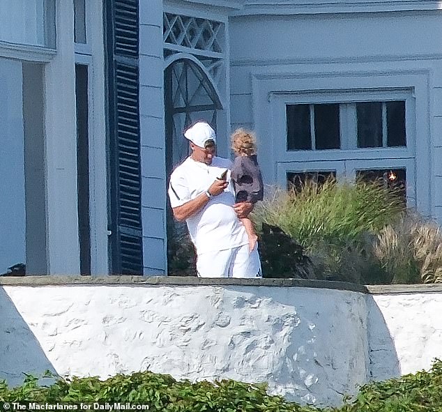 Mahomes could later be seen holding son Bronze, one, as he checked his phone