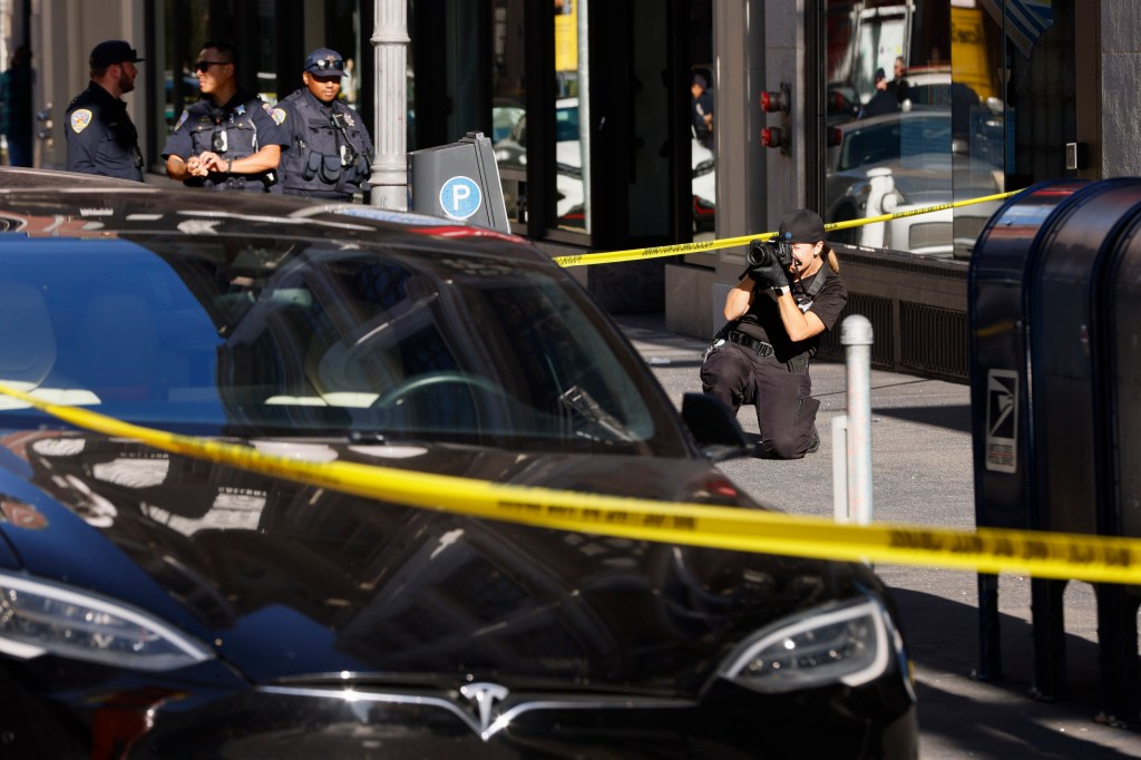 Police officers secure the area and investigate the scene of a shooting at Union Square in San Francisco on Saturday, Aug. 31, 2024.