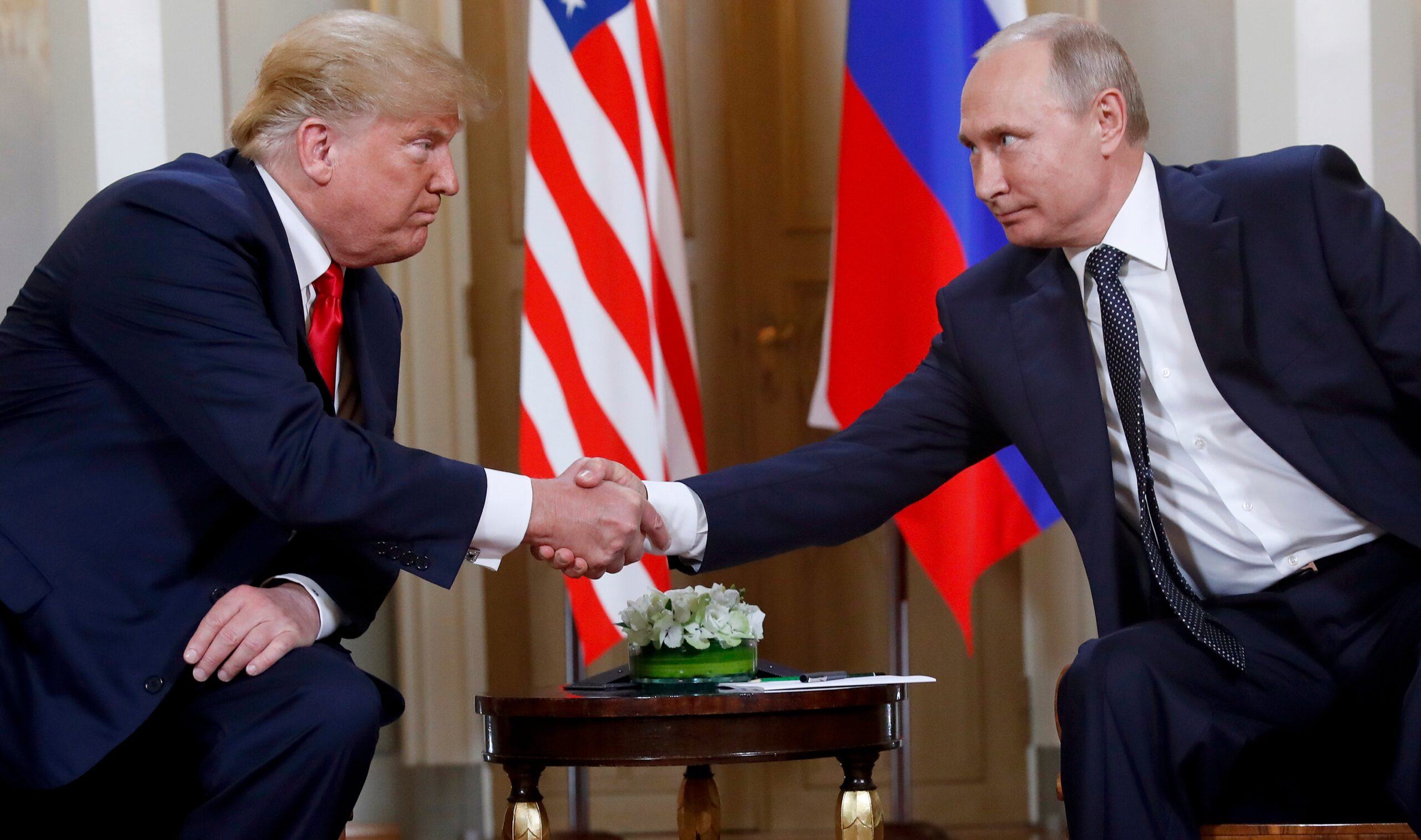 A former FBI official warns Trump could be a Russian asset if he wins the election. Trump is pictured with Putin in 2018