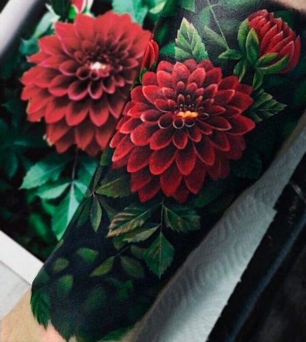 Vibrant red with green leaves tattoo